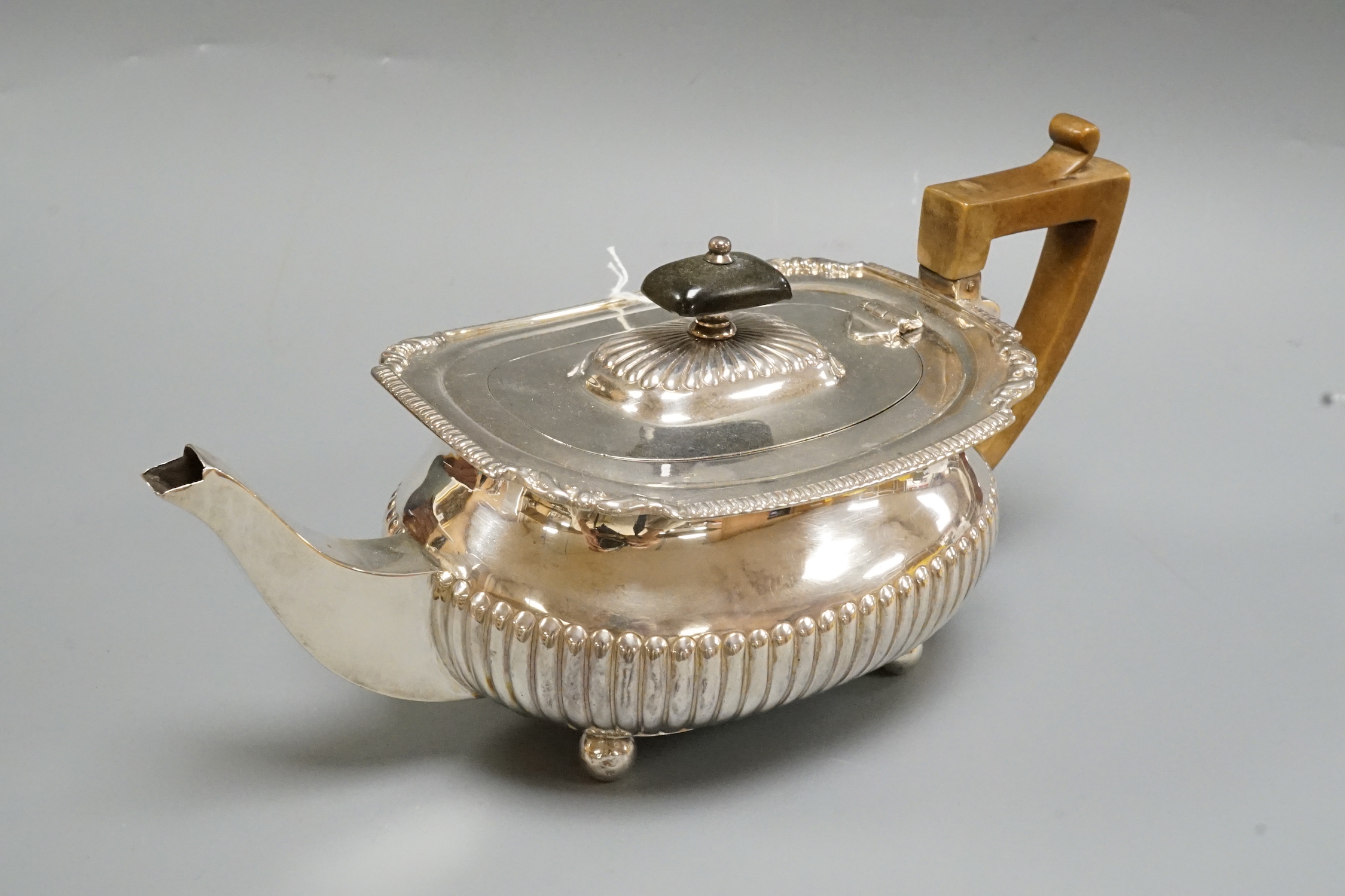 A Victorian demi-fluted silver teapot, Edward Hutton, London, 1883, gross weight 16oz.